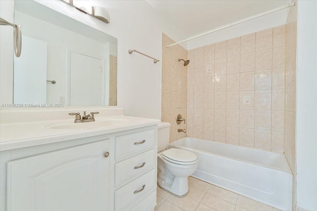 full bathroom featuring tile patterned flooring, vanity, tiled shower / bath combo, and toilet