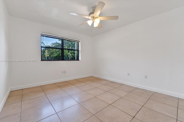 tiled empty room with ceiling fan