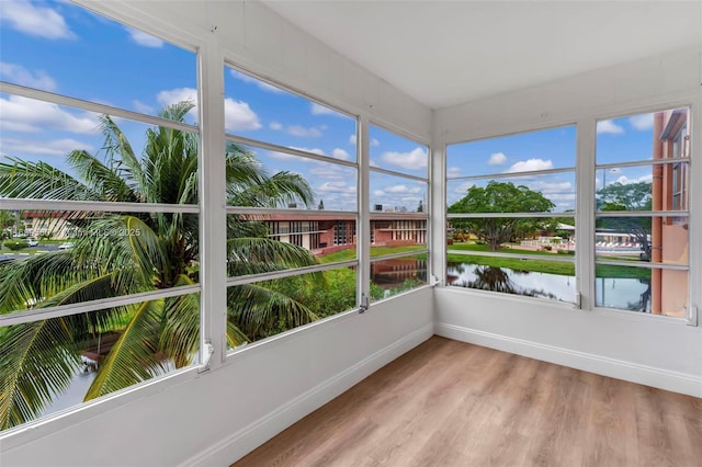 unfurnished sunroom with a water view