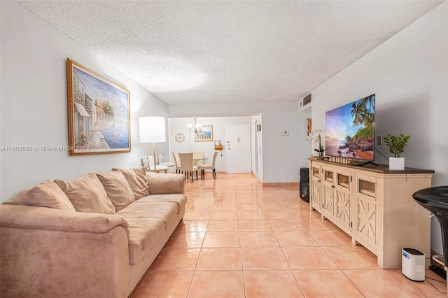 living room with light tile patterned floors and a textured ceiling