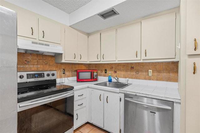 kitchen with white cabinets, sink, and stainless steel appliances