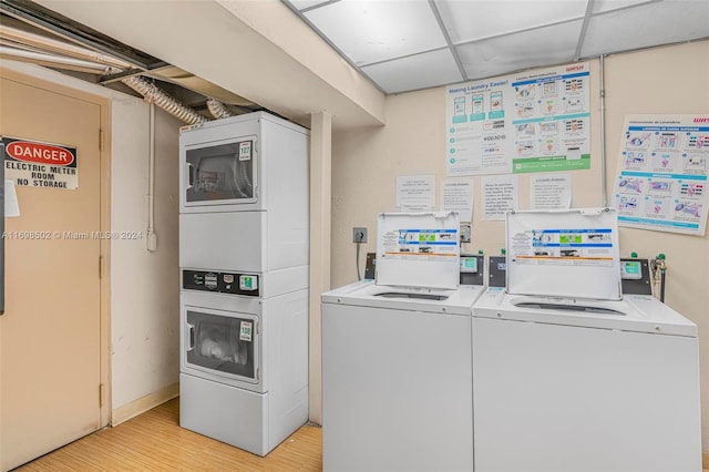 washroom featuring stacked washer / drying machine and light wood-type flooring