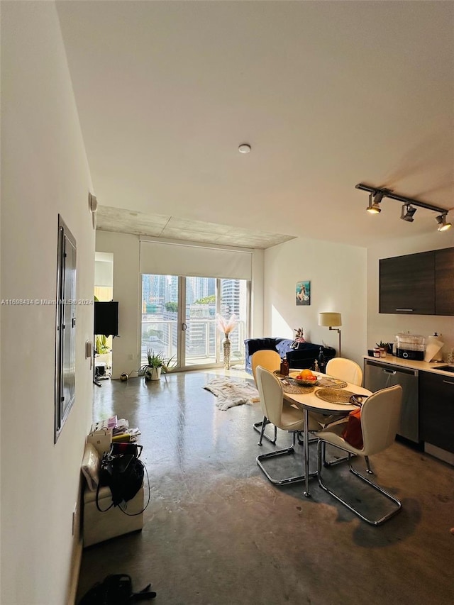 dining room with concrete floors and track lighting