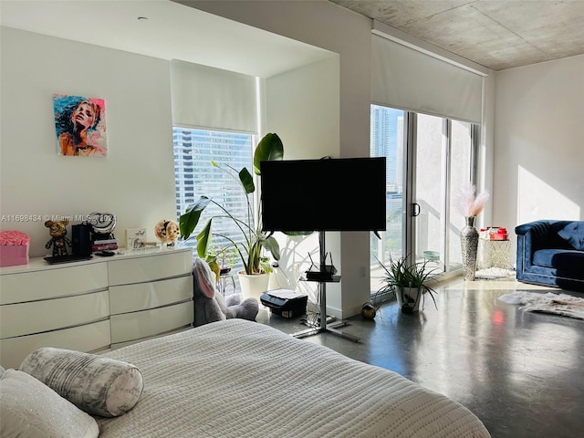 bedroom featuring concrete flooring