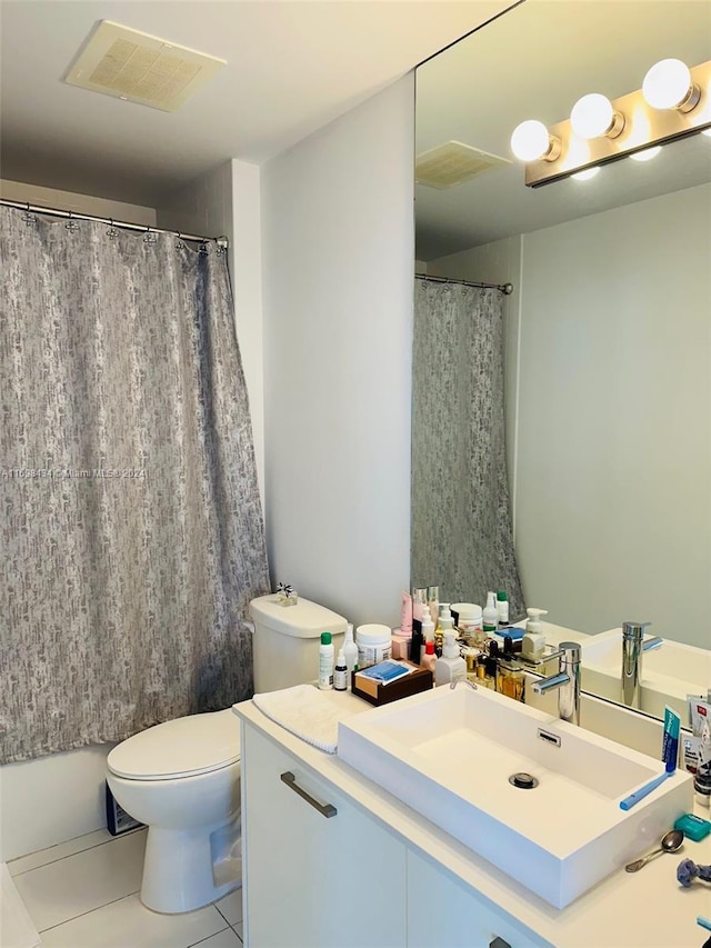 bathroom with tile patterned floors, vanity, and toilet