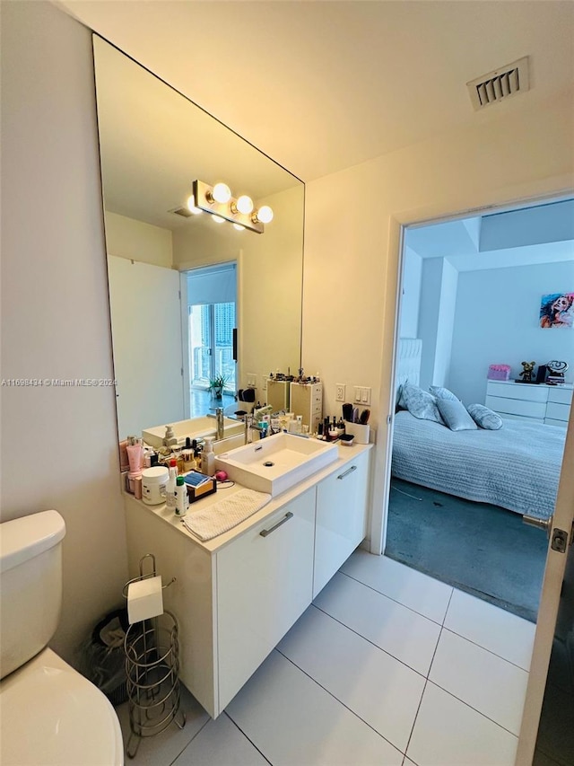 bathroom with tile patterned floors, vanity, and toilet