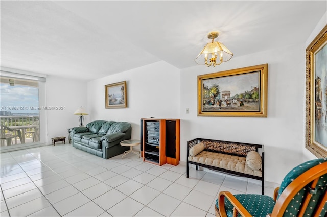 tiled living room featuring a notable chandelier