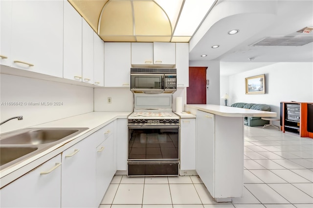 kitchen featuring sink, light tile patterned floors, kitchen peninsula, white cabinets, and black appliances