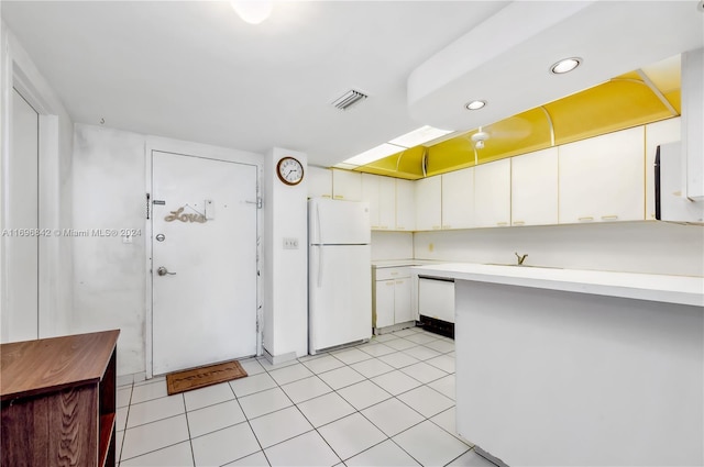 kitchen featuring white cabinets, white appliances, and light tile patterned flooring