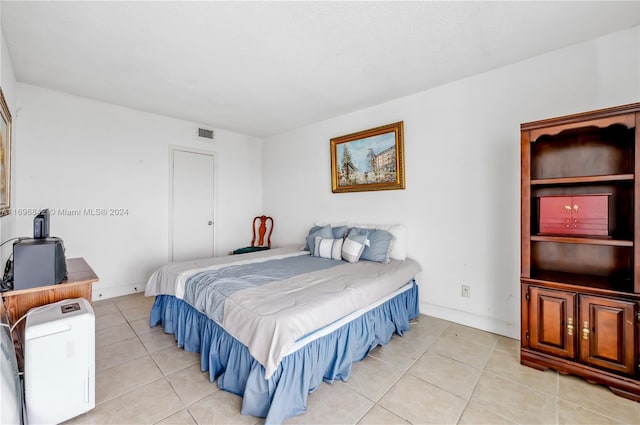 bedroom with light tile patterned flooring