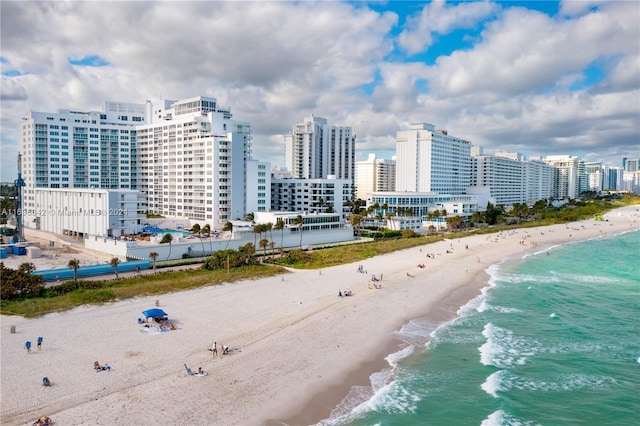 birds eye view of property with a water view and a view of the beach