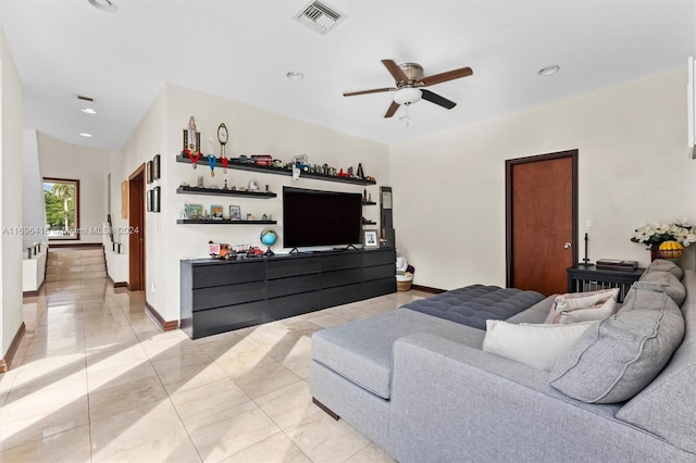 living room featuring light tile patterned floors and ceiling fan