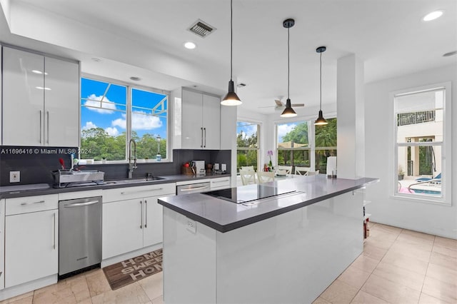 kitchen featuring white cabinetry, ceiling fan, hanging light fixtures, tasteful backsplash, and a kitchen island