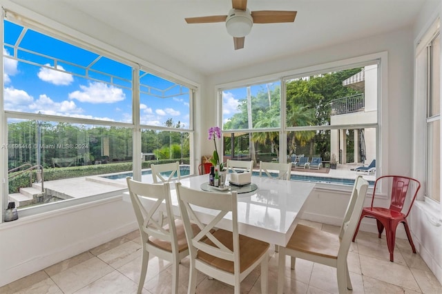 sunroom featuring ceiling fan