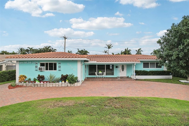 ranch-style home with a front lawn and cooling unit