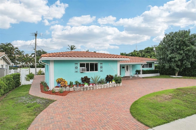 rear view of property featuring a lawn and cooling unit