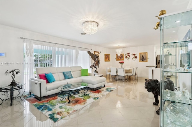 tiled living room featuring a chandelier