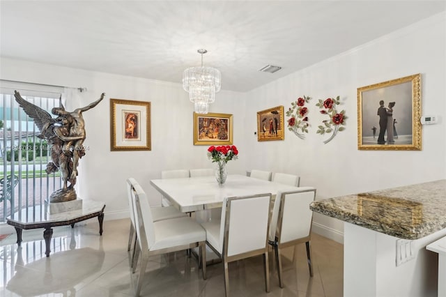 dining area featuring light tile patterned floors, ornamental molding, and a chandelier