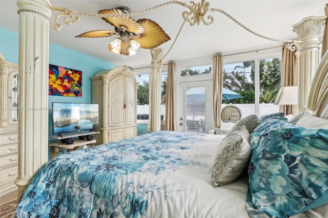 bedroom featuring ceiling fan, wood-type flooring, and access to outside