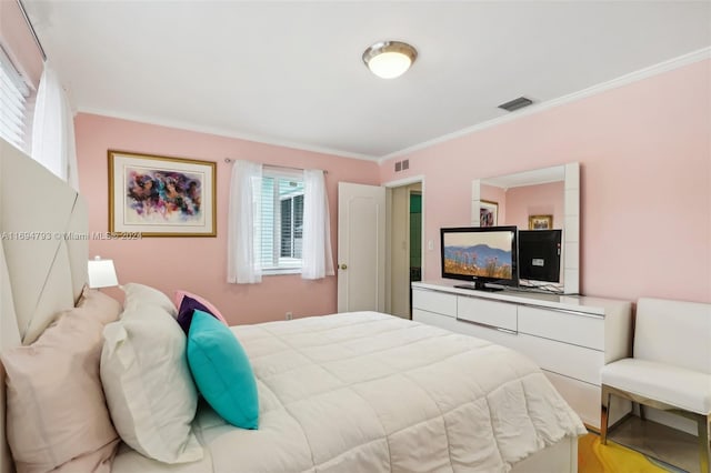 bedroom featuring light hardwood / wood-style flooring and crown molding