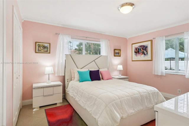 bedroom featuring light tile patterned floors, multiple windows, and crown molding