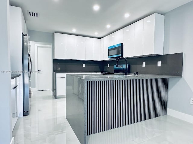 kitchen featuring white cabinetry and stainless steel appliances