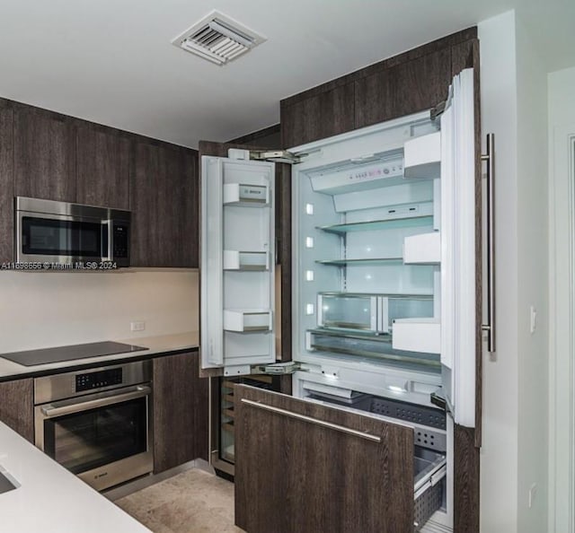 kitchen featuring dark brown cabinetry and stainless steel appliances