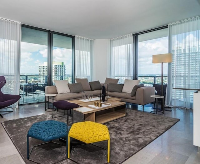 living room featuring plenty of natural light and a wall of windows