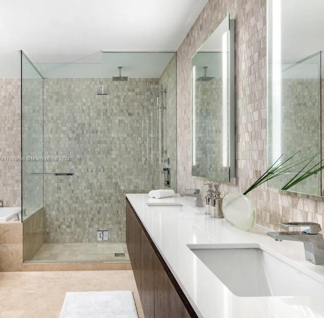 bathroom featuring tile patterned flooring, vanity, and tile walls