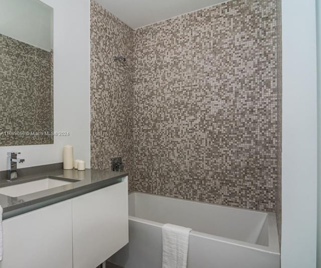 bathroom featuring vanity and tiled shower / bath