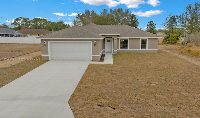 ranch-style home featuring a garage and a front lawn