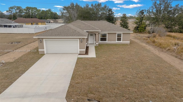 view of front facade with a garage and a front lawn