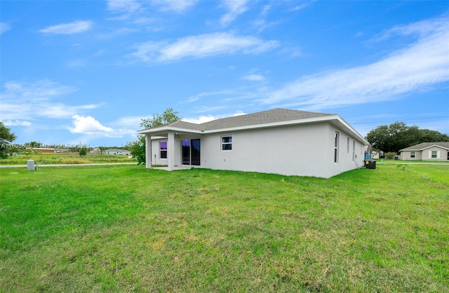 rear view of house with a yard