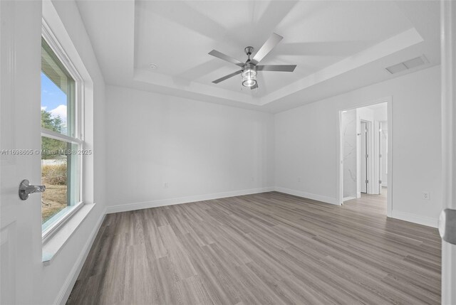 bathroom with hardwood / wood-style flooring, ceiling fan, and tiled shower