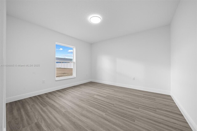 laundry area with hookup for an electric dryer, hookup for a washing machine, and light wood-type flooring