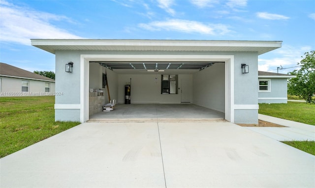 garage featuring water heater and a yard