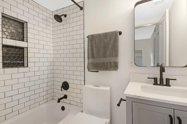 bathroom featuring vanity and tiled shower / bath