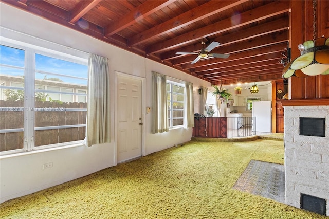 interior space featuring plenty of natural light, beam ceiling, wooden ceiling, and ceiling fan