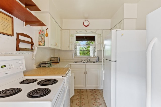 kitchen featuring white cabinets, white appliances, sink, and light tile patterned floors