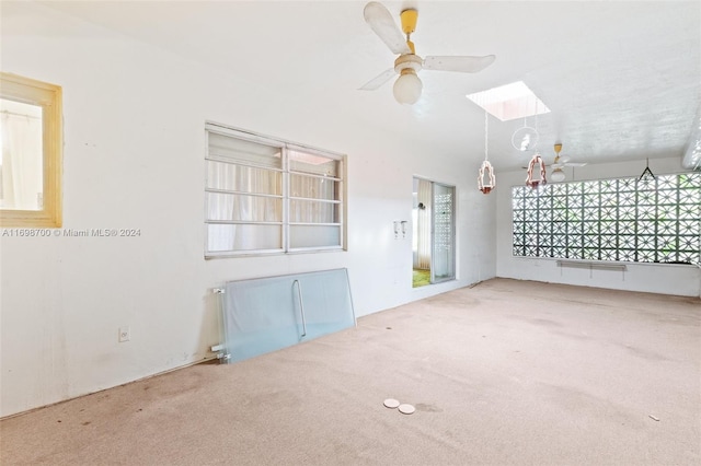 spare room featuring carpet, a wealth of natural light, and ceiling fan