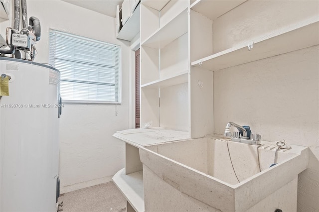 interior space featuring carpet, sink, and water heater