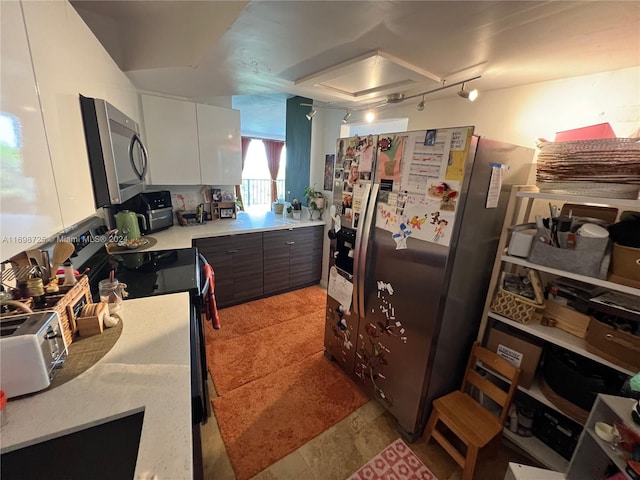 kitchen with dark brown cabinets, white cabinetry, and stainless steel appliances