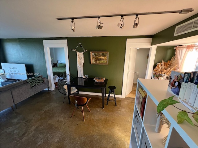 dining area featuring rail lighting