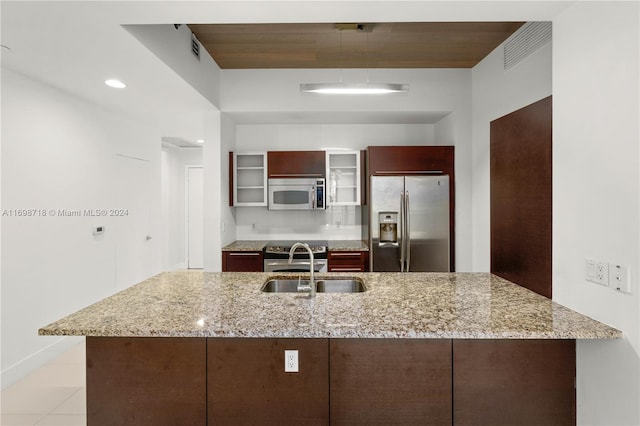 kitchen with light stone countertops, sink, light tile patterned flooring, and stainless steel appliances