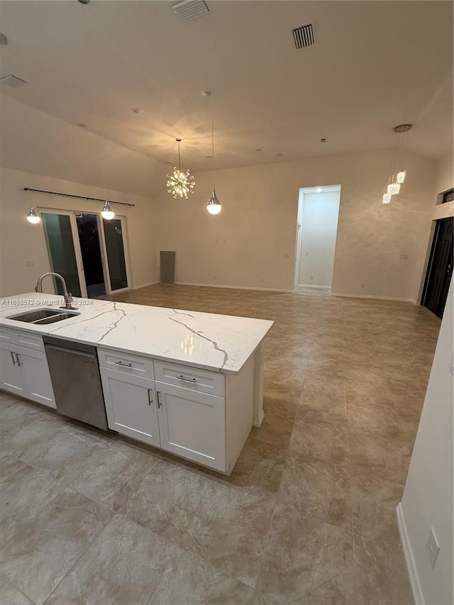 kitchen featuring light stone counters, stainless steel dishwasher, sink, pendant lighting, and white cabinets