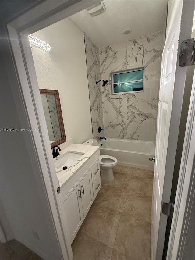 full bathroom with toilet, vanity, and tiled shower / bath