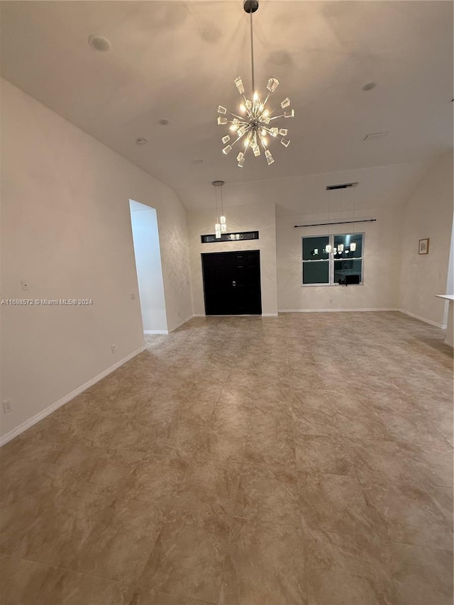 unfurnished living room featuring an inviting chandelier