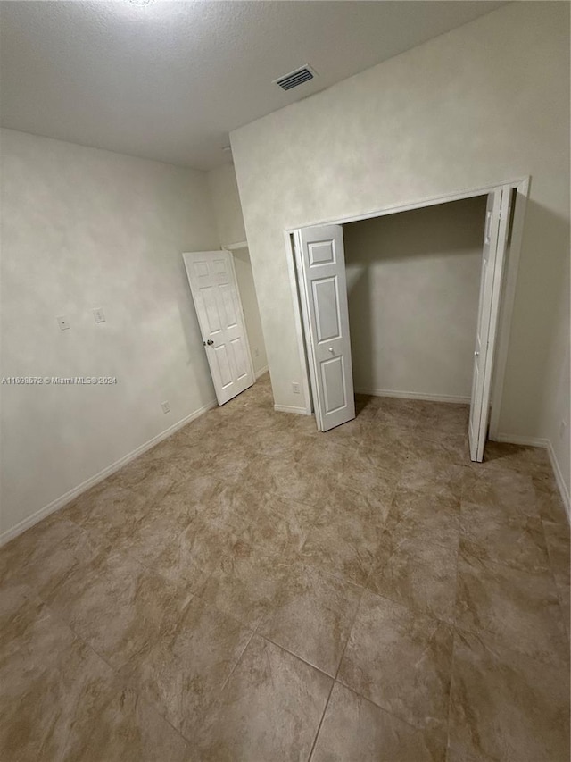 unfurnished bedroom with a closet