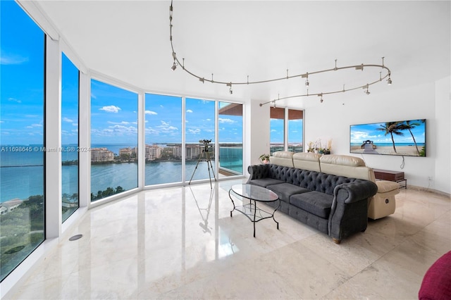 living room featuring a wall of windows and rail lighting