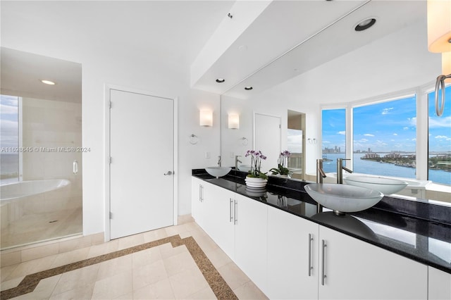 bathroom with an enclosed shower, vanity, a water view, and a wealth of natural light